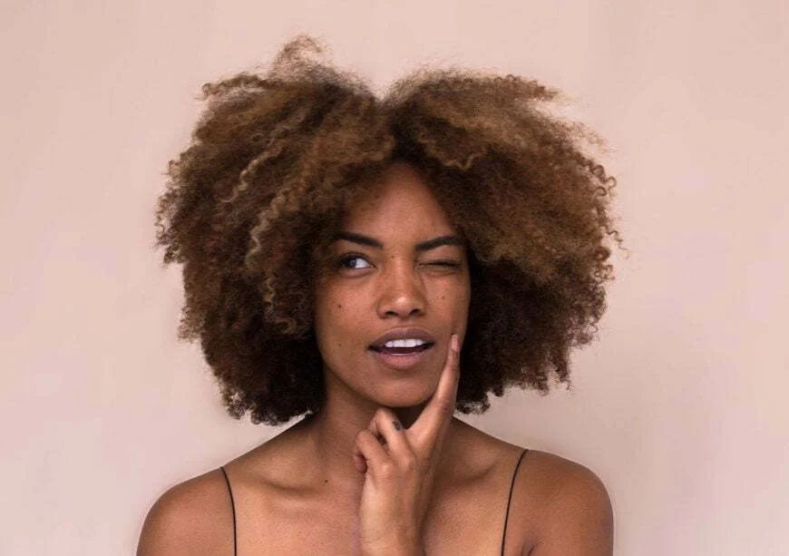 A young woman winking representing anti-aging tips