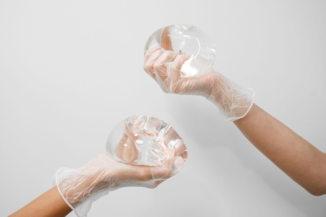 Hands holding breast implants