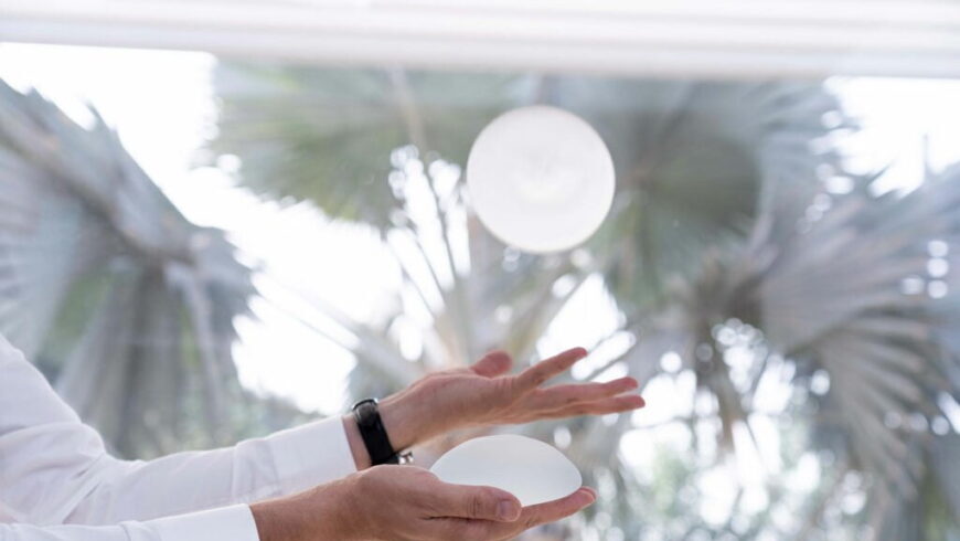 Hands holding implants