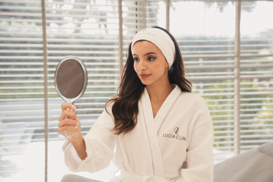 A woman looking at a mirror after breast surgery