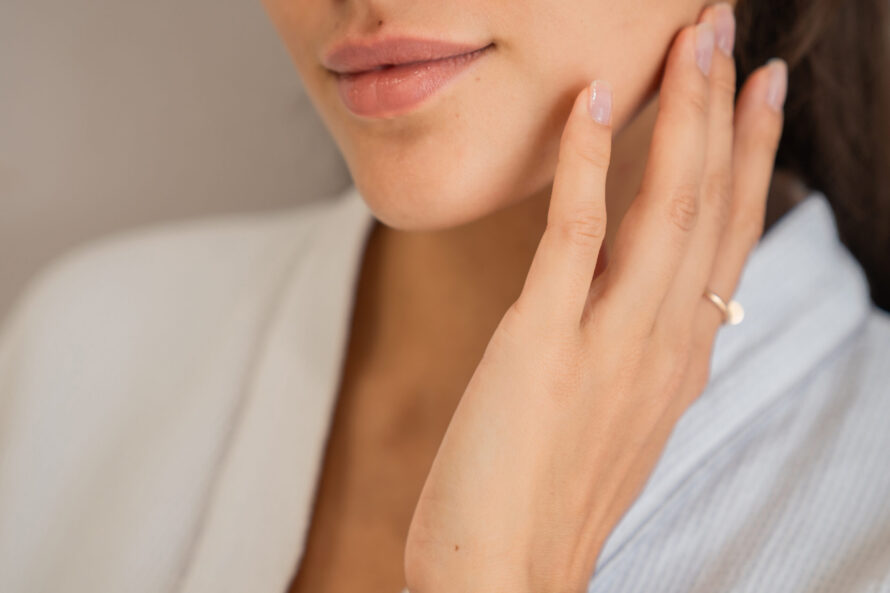 A woman touching her skin
