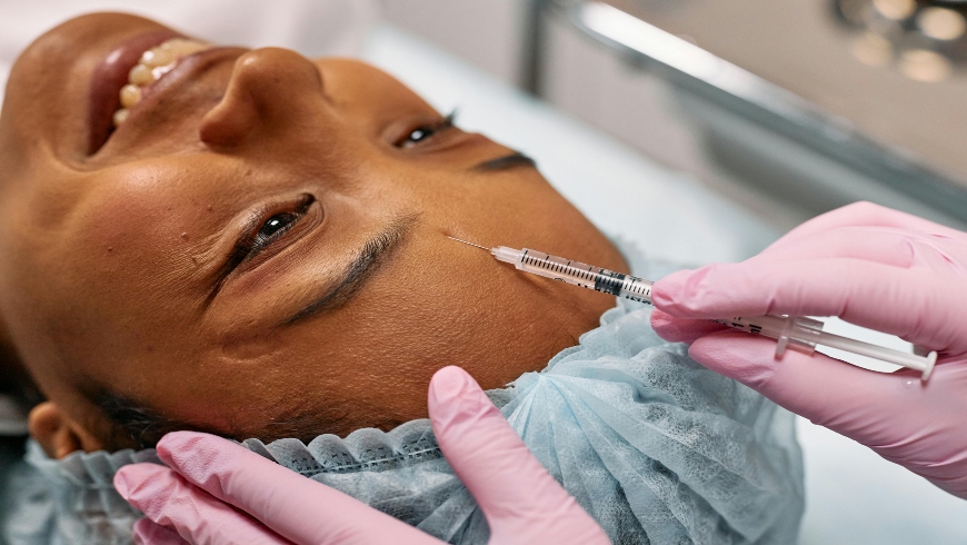 A woman getting botox injections after consulting with a dermatologist on how to get rid of fine lines between eyebrows