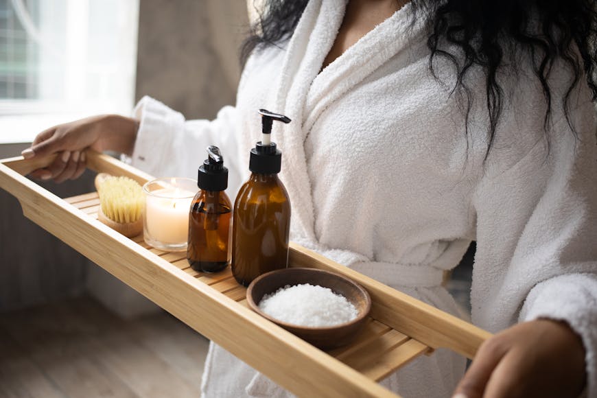 A woman carrying a tray with spa products.