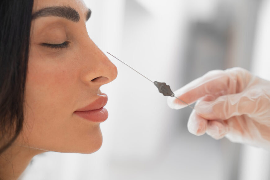 A woman at a recovery consultation after rhinoplasty