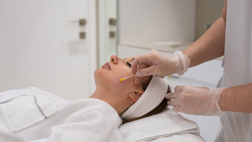 A woman getting a facial treatment