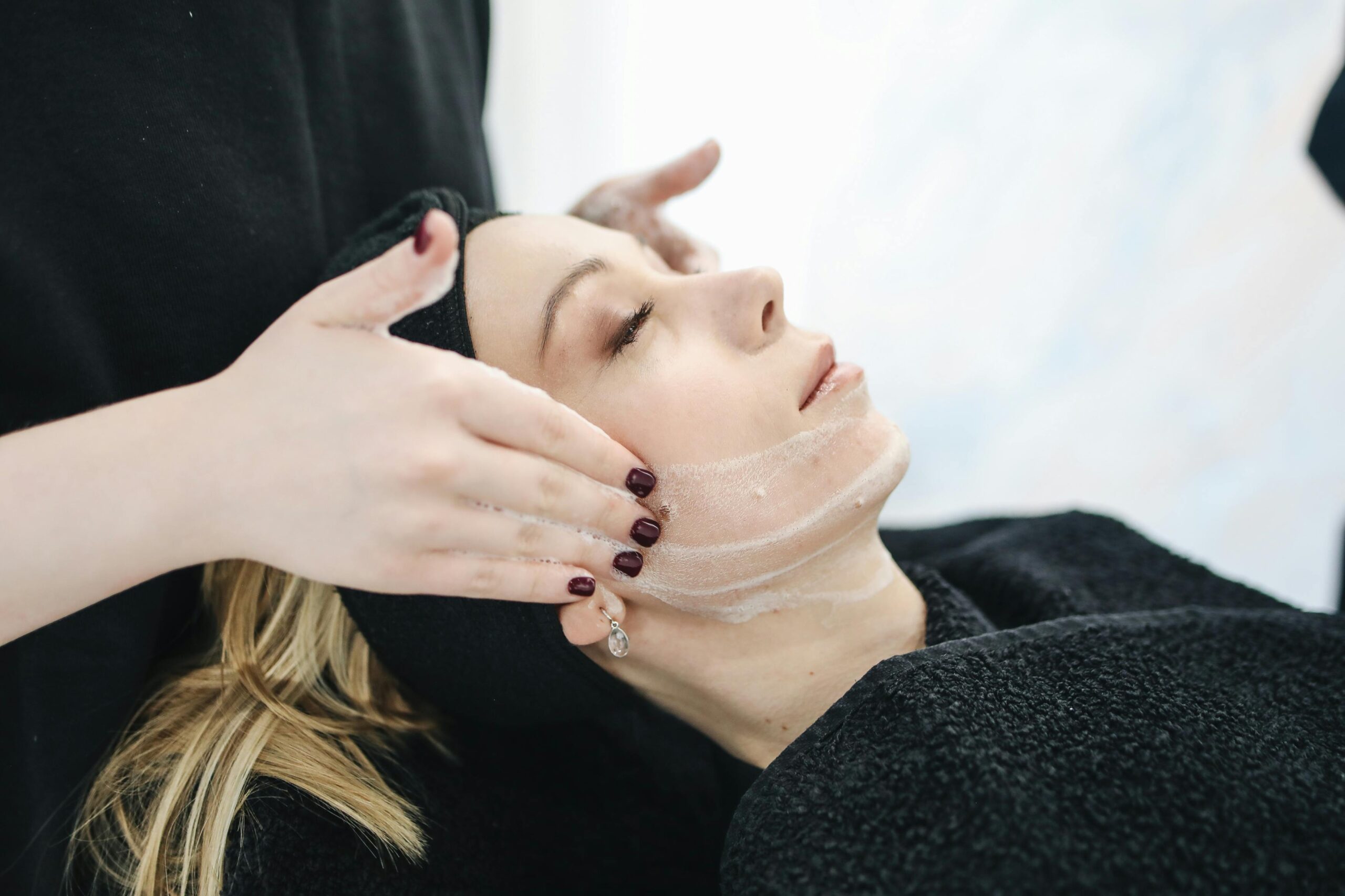 Woman getting a facial treatment after debunking common myths about aesthetic treatments