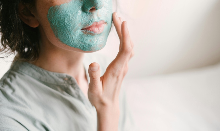 Woman putting a face mask on her skin