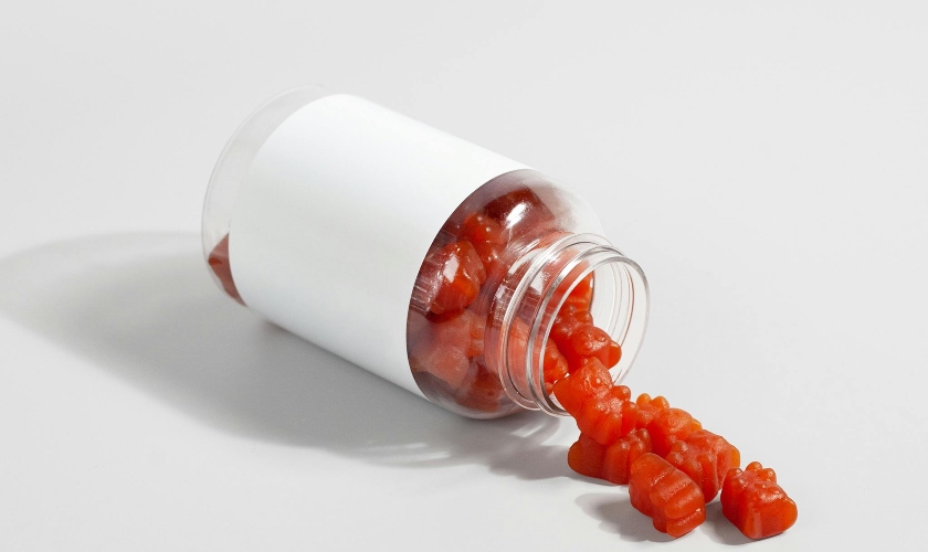 Supplement red gummies in a glass bottle