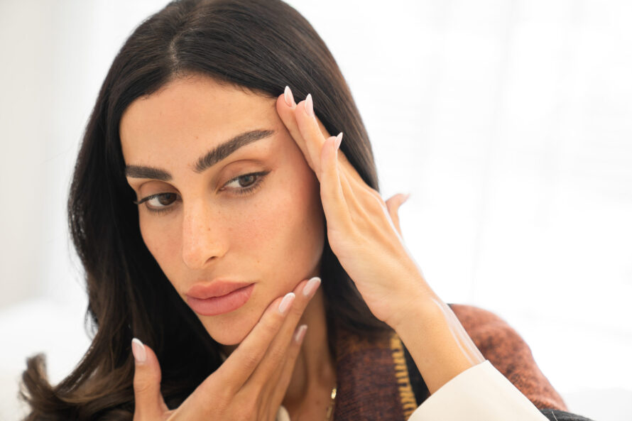 A woman touching her face