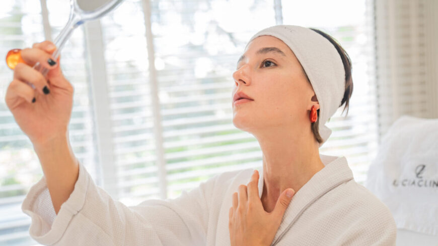 A woman looking at a mirror after a surgery